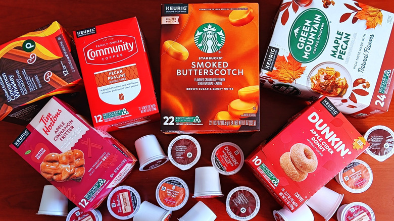Six boxes of popular brands of fall flavored coffee K-cups with loose pods.