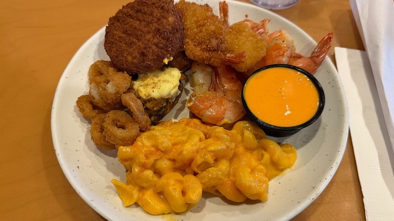 Plate of fried seafood and mac and cheese on table at Shady Maple Smorgasbord