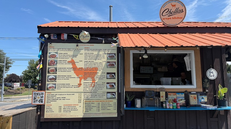 Standing outside of Chella's Arepa Kitchen food truck, menu and window showing