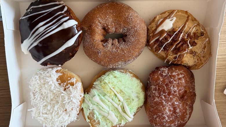 Six doughnuts from Beiler's in box on wooden surface