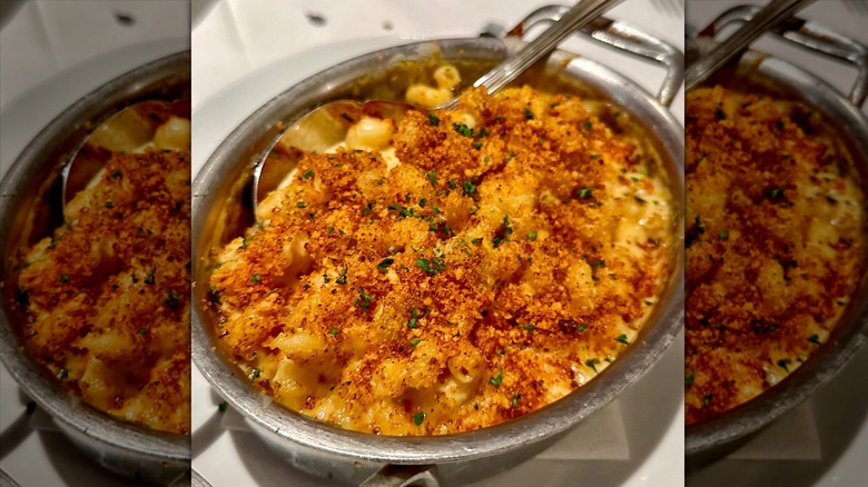 Fleming's Prime Steakhouse & Wine Bar's chipotle cheddar mac & cheese in a silver baking dish on a white plate