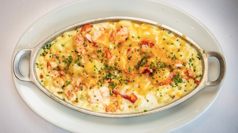 Ruth's Chris Steak House's lobster mac & cheese in a silver dish on a white plate