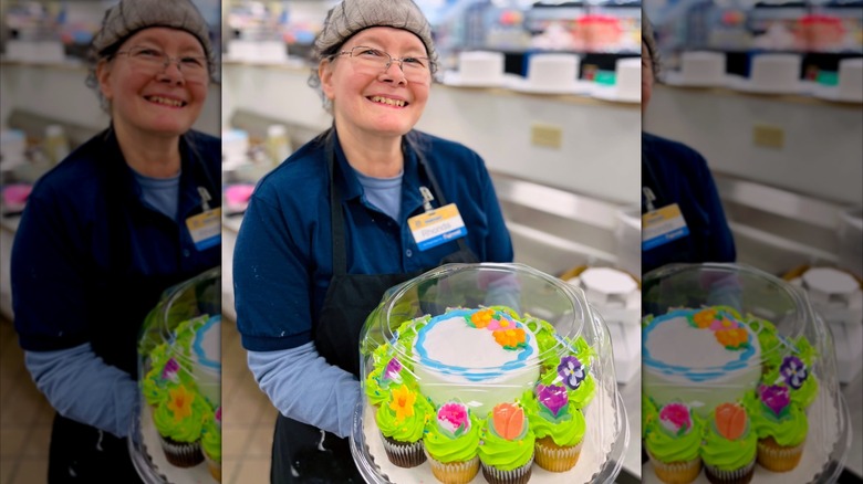 Walmart employee holding tray with cake and cipcakes
