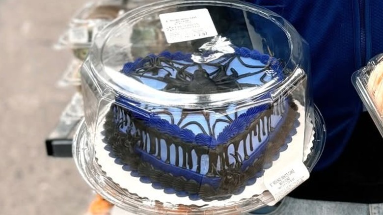 Heart-shaped cake from Walmart with spider decoration and black and blue frosting