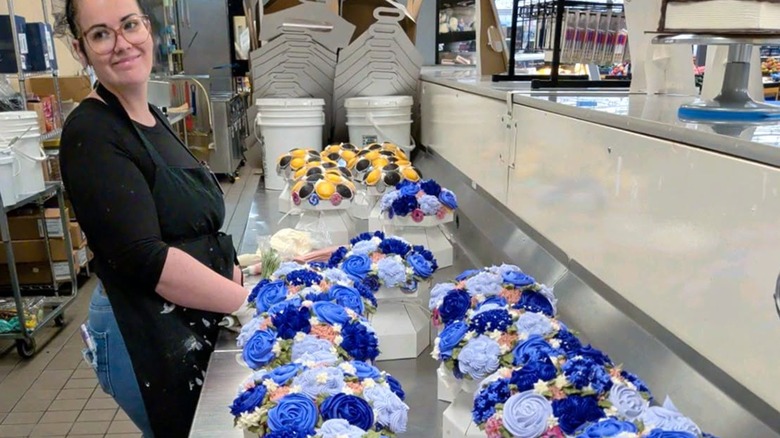 Walmart cake decorator with counter full of cakes