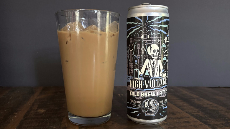 Bones Coffee Company High Voltage RTD canned latte in glass with ice on wooden table