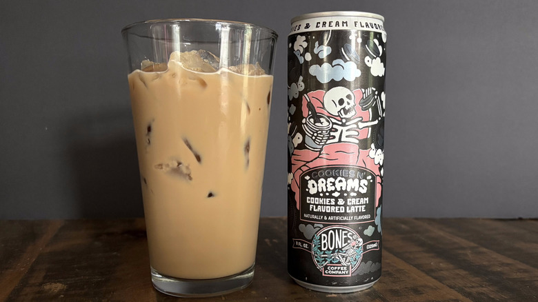 Bones Coffee Company Cookies N' Dreams RTD canned latte in glass with ice on wooden table