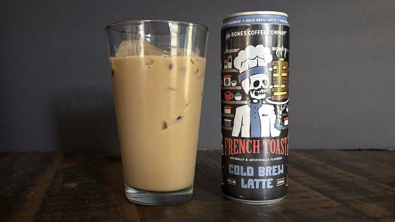 Bones Coffee Company French Toast RTD canned latte in glass with ice on wooden table