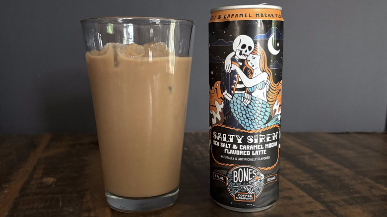 Bones Coffee Company Salty Siren RTD canned latte in glass with ice on wooden table