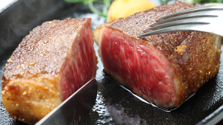 Close up of cut steak on pan