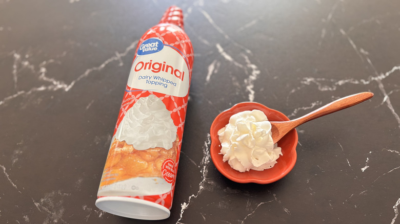 Walmart Great Value whipped cream can next to small bowl of whipped cream