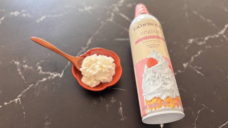 Small bowl of whipped cream next to Favorite Day whipped cream can