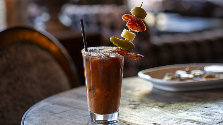 A bloody mary drink with a garnish at a restaurant
