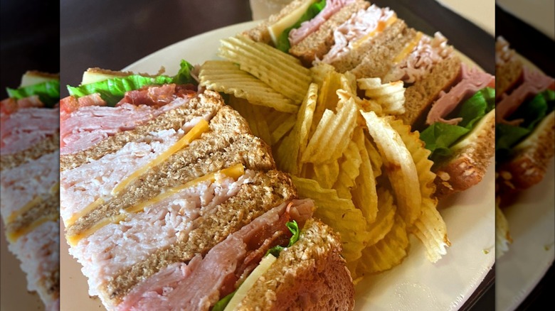 Club sandwich with chips and a drink at Jason's Deli