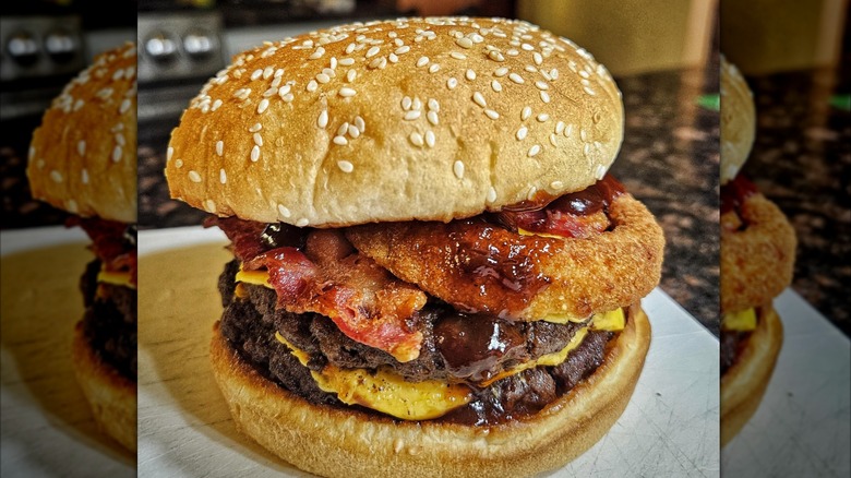 Carl's Jr. Western Bacon Cheeseburger sitting on a cutting board in a kitchen.