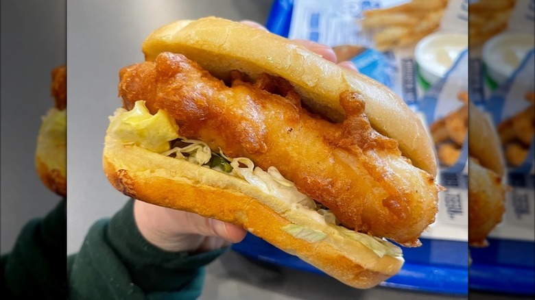 Hand holding Culver's fish sandwich
