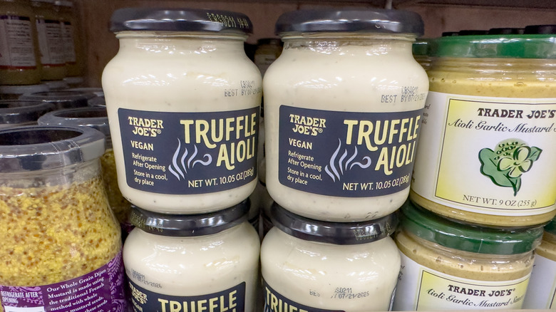 Jars of Trader Joe's truffle aioli and aioli garlic mustard on shelf in store