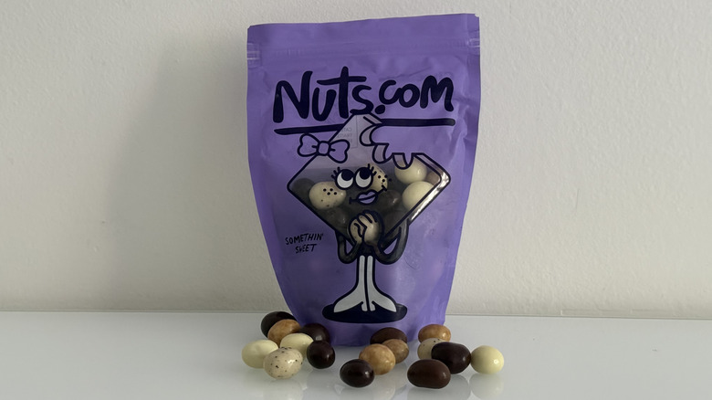 Chocolate covered espresso beans in five flavors in front of pouch
