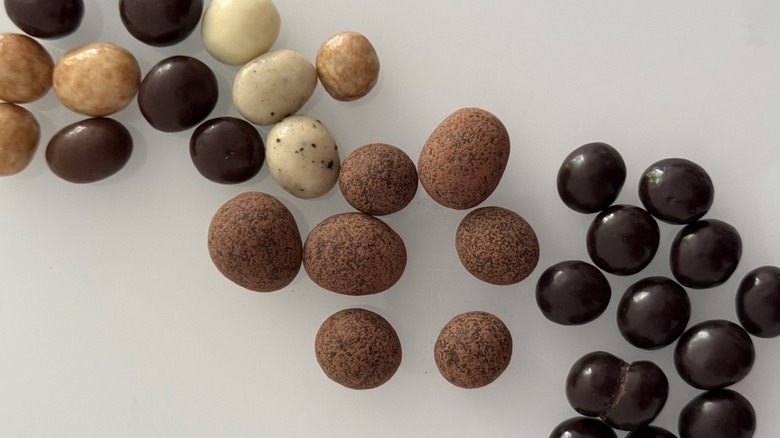 Top shot of various chocolate covered espresso beans arranged in diagonal line