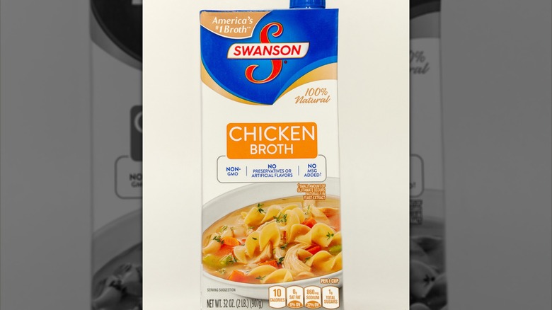 Carton of Swanson chicken broth on a white background