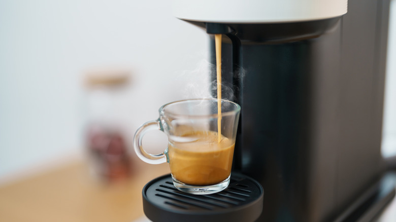 espresso machine brewing into clear espresso cup