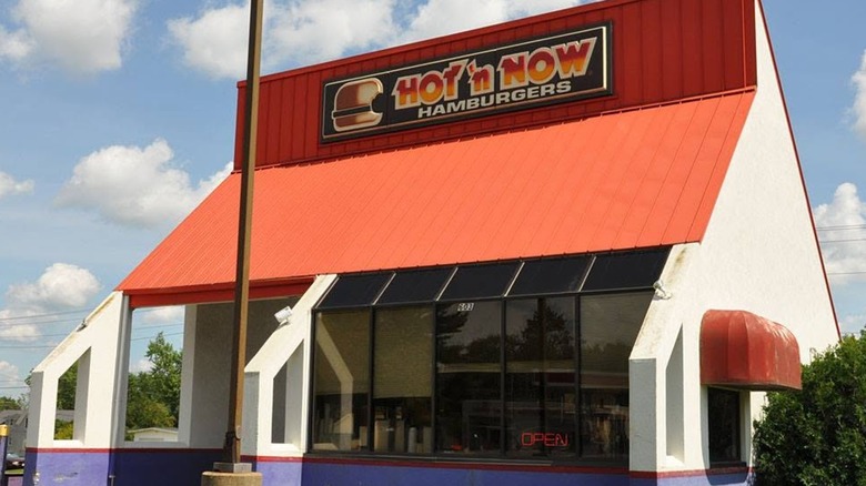 A red and white building with a sign that reads "Hot 'n Now"