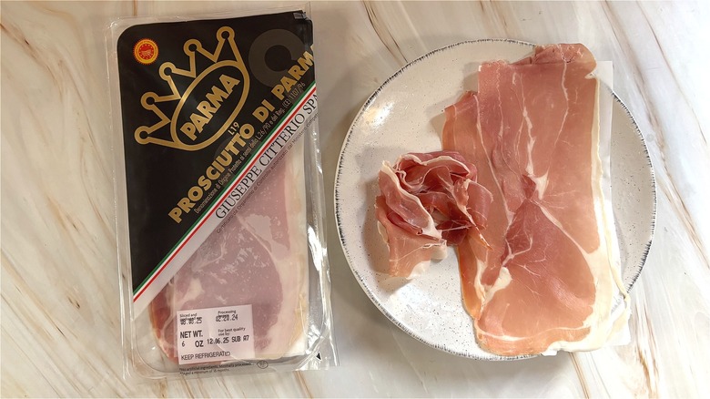 Slices of Citterio Prosciutto di Parma on white plate next to package on table