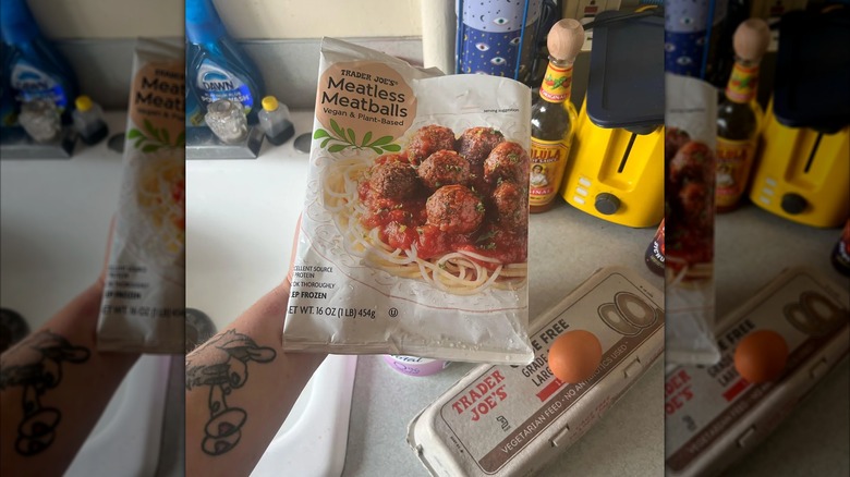Someone holding Meatless Meatballs bag by kitchen counter