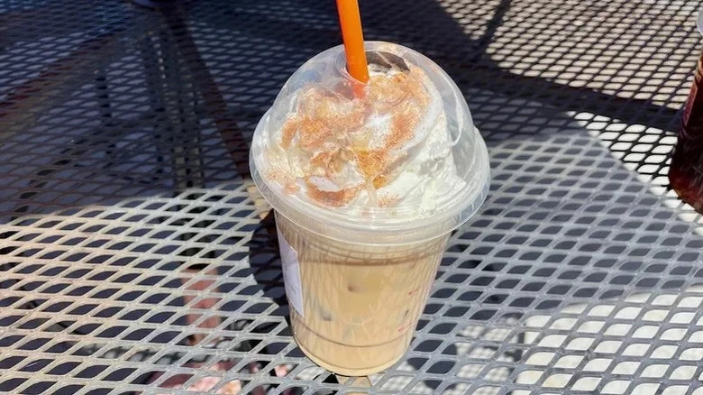 Caramel Craze latte placed on a corrugated metal table