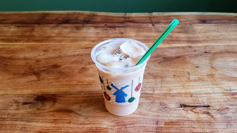 Dutch Bros protein latte on a wood table.
