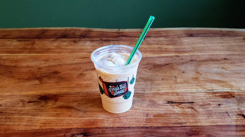 Dutch Bros protein mocha beverage on a wooden table.