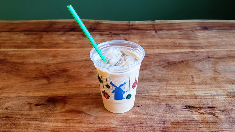 Vanilla protein latte by Dutch Bros on wooden table.