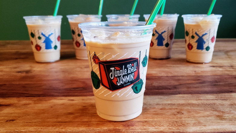 Six Dutch Bro protein coffee drinks on a wood table.
