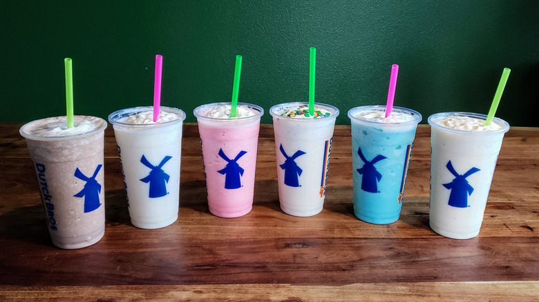 Dutch Bros shakes on a wooden table.