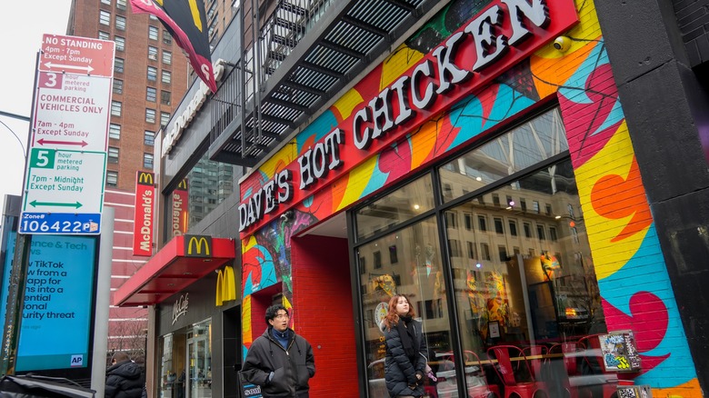 People walking past Dave's Hot Chicken location in NYC