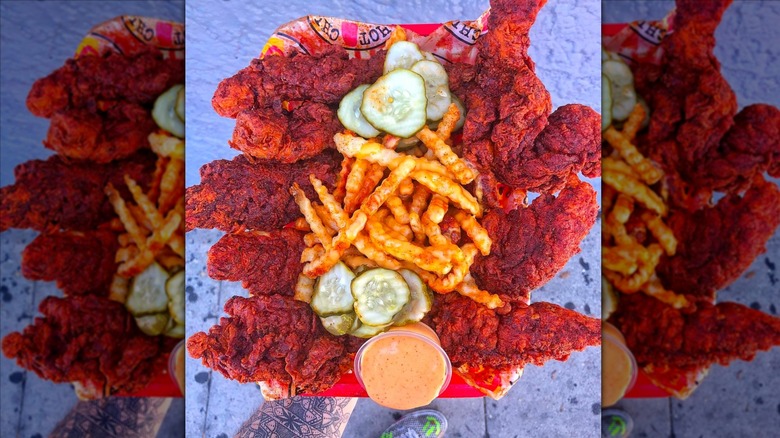 Dave's Hot Chicken chicken tenders, pickles, and fries