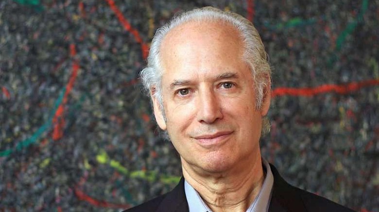 Zev Siegl posing in front of splatter art