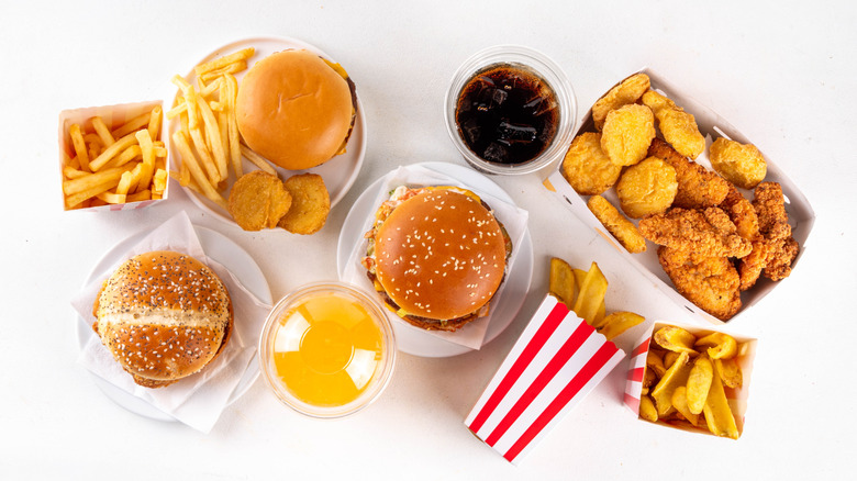 Various fast food menu items arranged on white table