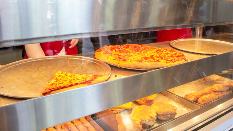 Cheese and pepperoni pizza at display window in Costco