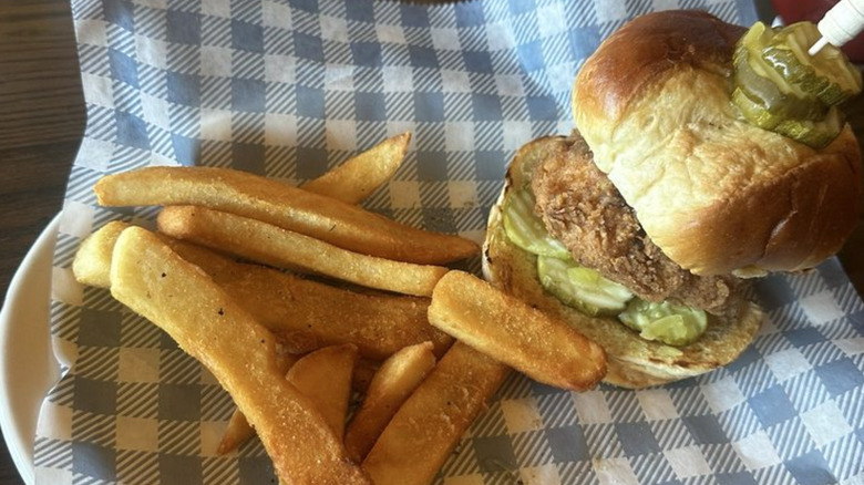 A fried chicken sandwich and fries from Cracker Barrel on a plate