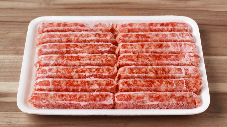 Package of frozen sausages with freezer burn