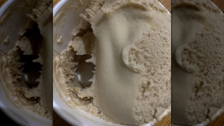 Mirrored image of thawed and refrozen ice cream tub