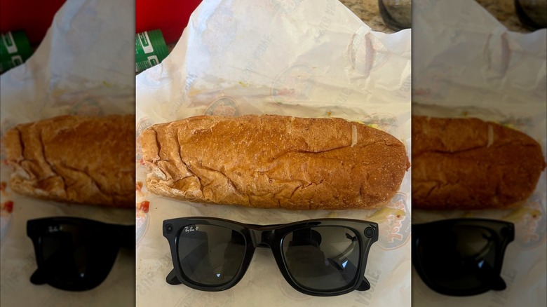 Sandwich on white wrapper next to a pair of sunglasses, mirrored image