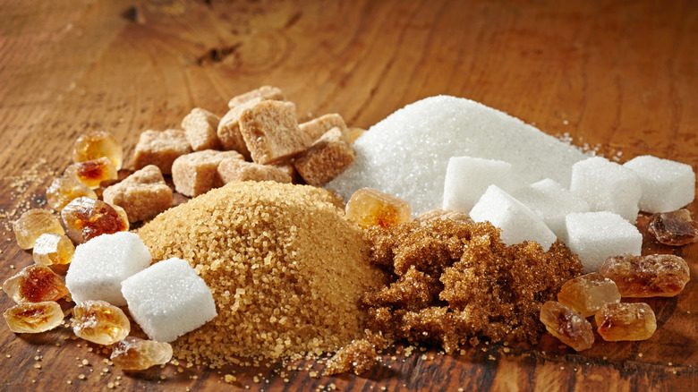 Various types of sugar on wooden table