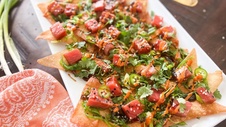 Poke nachos with tuna on rectangular white plate