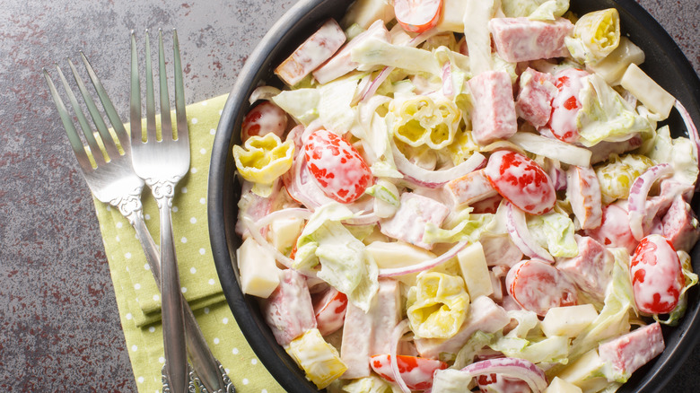 Chopped Italian sub toppings in a bowl with creamy sauce