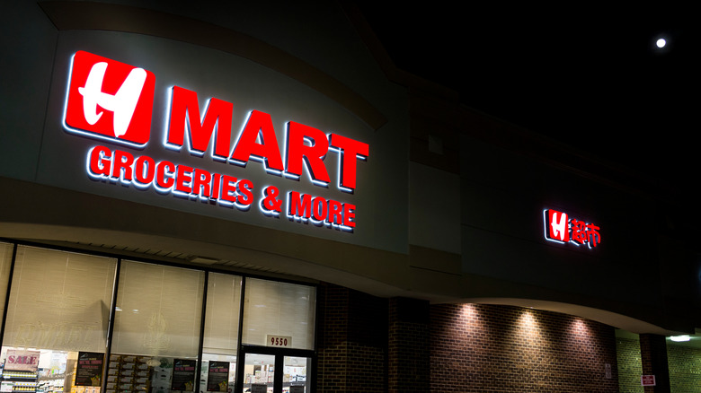 Red H-Mart sign on store building at night