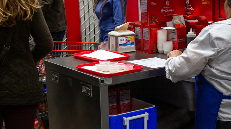 Person working a sample cart at Costco