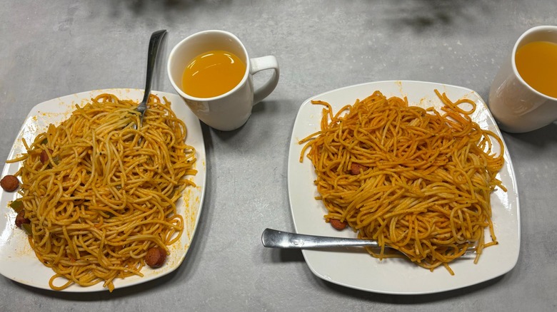 A plate of spaghetti with hot dogs