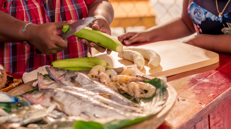 A woman slicing plantains